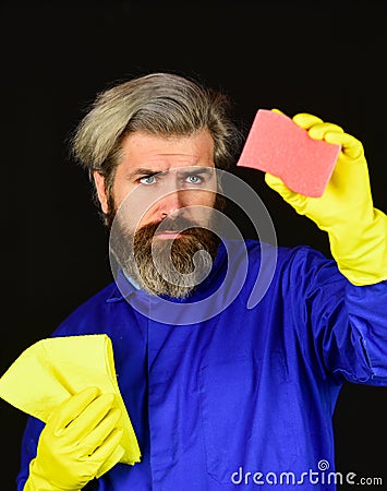 Duty and cleaner. male using sponge. Take care hygiene. bearded man in yellow rubber gloves wiping dust using duster Stock Photo