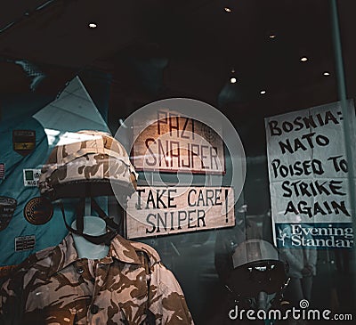 Duxford England May 2021 Exhibit of a sign saying Pazi Sniper, translated into Take Care Sniper, from the sniper alley of Sarajevo Editorial Stock Photo