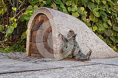 Dwarf guards the entrance of a small building Editorial Stock Photo