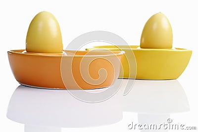 Dyed Ester eggs in colorful ceramic egg cups Stock Photo