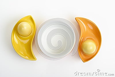 Dyed Ester eggs in colorful ceramic egg cups Stock Photo