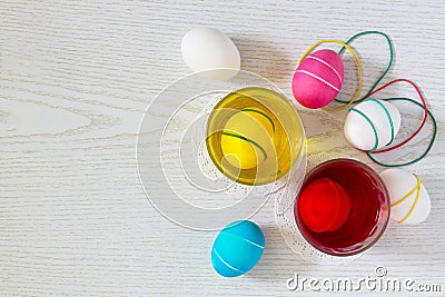 Dyeing Easter eggs with different colors of dye and elastic bands Stock Photo