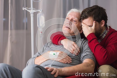 Dying father and despair son Stock Photo