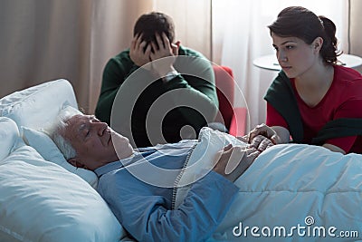 Dying man and despaired children Stock Photo