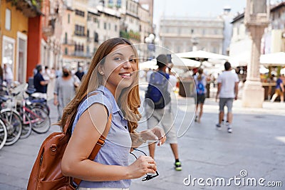 Dynamic attractive traveler girl visits Italy with friends. Beautiful young tourist woman doing a quick tour of Europe in company Stock Photo