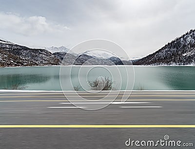 Dynamic blur road and snow lake Stock Photo