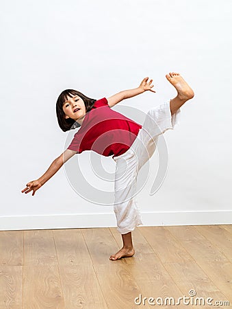 Dynamic child enjoying fighting tai chi, kung fu or taekwondo Stock Photo