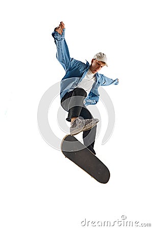 Dynamic image of young man in casual clothes in motion, training, skateboarding isolated over white background Stock Photo