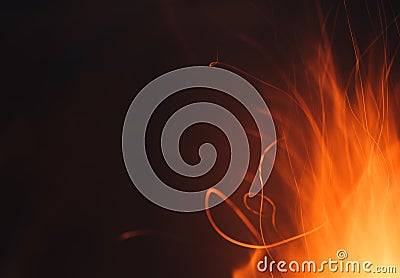 Dynamic lines traces of red hot sparks from the fire at night Stock Photo
