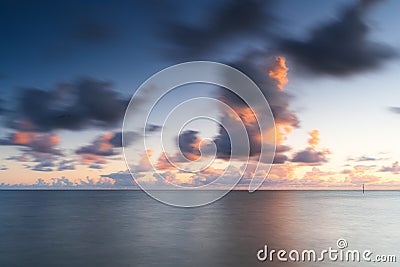 Dynamic sunset cloudscape above the IJsselmeer lake near town Stavoren, Friesland, Netherlands Stock Photo