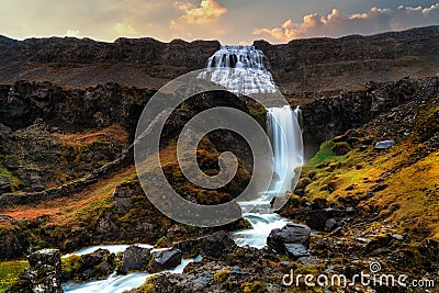 Dynjandi waterfall with tiered waterfalls in the foreground. Shot during early morning sunrise during autumn. Long Exposure Stock Photo