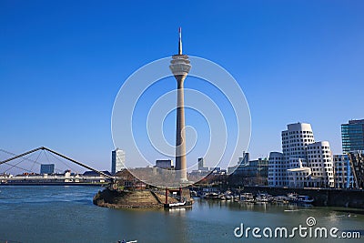 Panoramic view from medienhafen on Gehry houses, tv tower and bridge against deep blue cloudless sky in winter Editorial Stock Photo