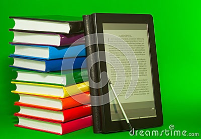 E-book reader with stack of printed books Stock Photo