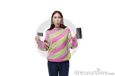e-business concept. 35 year old feminine model woman dressed in a pink and green pullover holding a credit card mockup Stock Photo