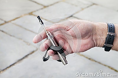 E Cigarette held in the palm of a mans hand Stock Photo