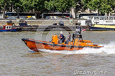 London, UK - 25 July, 2018: E-class Lifeboat of Royal National Lifeboat Institution RNLI sails London River Thames at hight spee Editorial Stock Photo
