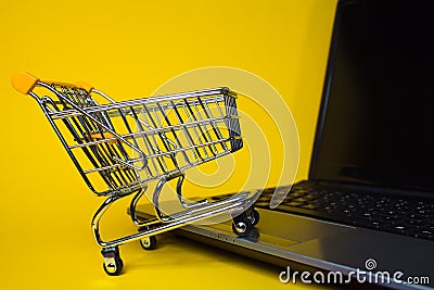 E-Commerce. Online shopping, shopping cart on laptop keyboard. Stock Photo