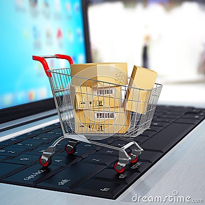 E-commerce. Shopping cart with cardboard boxes on laptop. Stock Photo