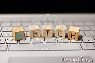 E file text on wooden blocks, Concept of tax filing through e file Stock Photo