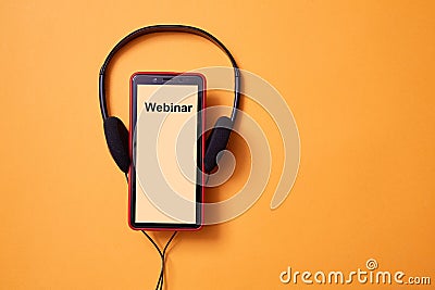 E-learning and online education concept. Webinar, internet lesson and courses. Headphones and smartphone. Copy space Stock Photo