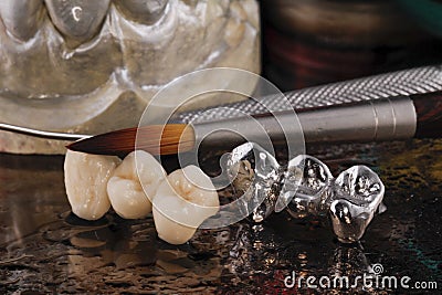 E-max pressed ceramic bridge and metal crown with dentistry utensils and mockup Stock Photo