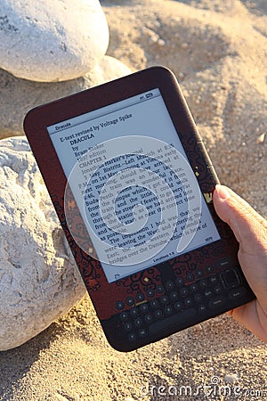 E-Reader being used on Beach Editorial Stock Photo