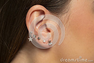 Ear piercings photos.Helix piercing.Ear rings Stock Photo