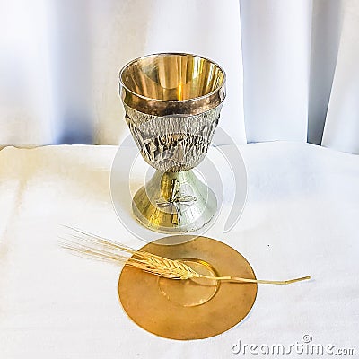 Ear of wheat for bread which becomes the body of Christ and chalice to house wine, the blood of Christ Stock Photo