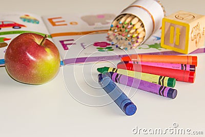 Early childhood learning with book and crayons. Stock Photo