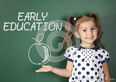 Early education concept, child girl near school blackboard Stock Photo