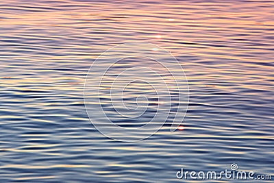 Early evening sun shimmering on calm water Stock Photo