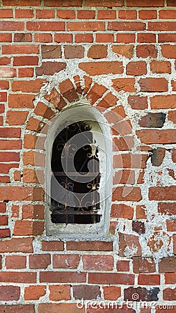 Early gothic window in a small country church, Gothic red brick architecture in the Baltics Stock Photo