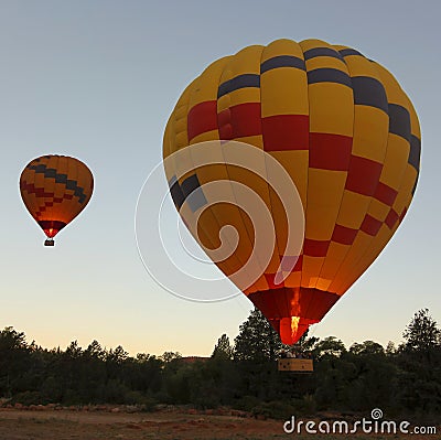 A Predawn Double Hot Air Balloon Liftoff Stock Photo