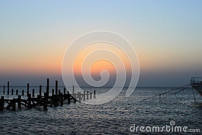 Early morning a few minutes before dawn. Sunrise on the sea. Cloudless sky is painted in shades of pink and orange. Red sea, Stock Photo