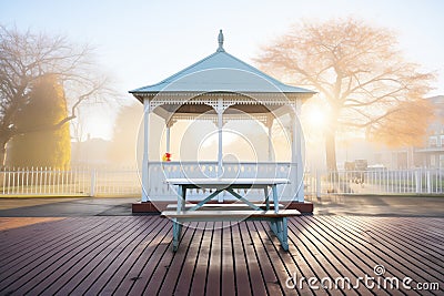 early morning frost on gazebo with empty benches Stock Photo