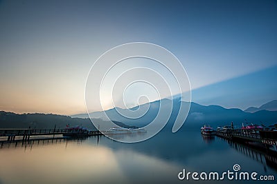 Early morning lake and mountain views. The clouds and mist are changing Stock Photo