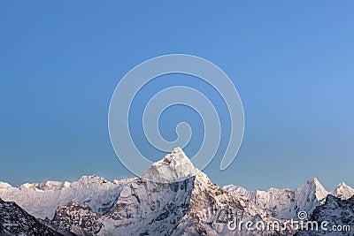 Early morning lights over the mountain Ama Dablam. Stock Photo