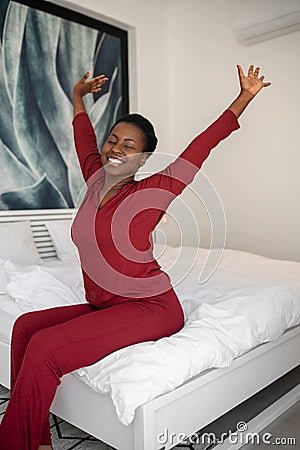Black African woman stretching on bed, morning routine, new day and start Stock Photo
