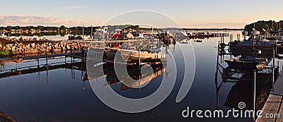 Early morning sun rays on a marina, boats, docks Editorial Stock Photo