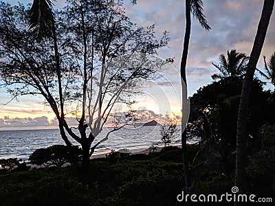 Early Morning Sunrise on Waimanalo Beach over ocean Stock Photo