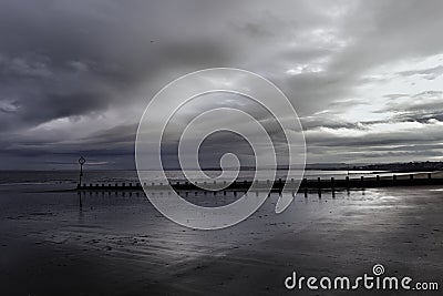 Early overcast morning on the beach at low tide Stock Photo