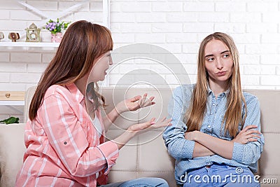 Early pregnancy. Mother and daughter abuse and sitting on sofa at home background. Copy space and mock up Stock Photo
