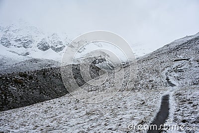 Early snow covers the mountain trail to Lake Donguzorun Kol Stock Photo