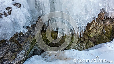 Early spring. The icicles on the rocks begin to melt. Stock Photo