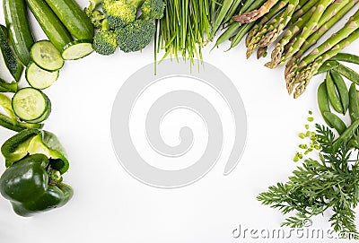 Spring veggies, isolated. Green seasonal vegetables on a white background, top view. Frame with a copy space. Stock Photo
