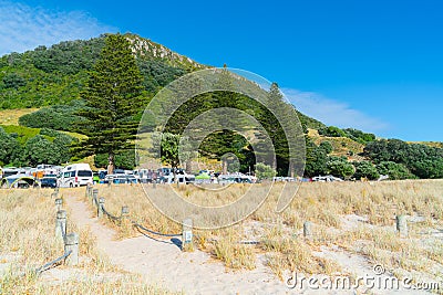 Early start to day walkers out on Mount boardwalk in front of Mount Camp and under landmark mountain Editorial Stock Photo