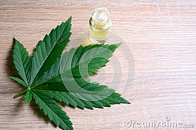 Earnings from the sale of cannabis medicament products. Cannabis leaf, hemp oil and money Stock Photo