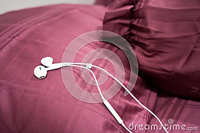 White earphone on the wooden table Stock Photo