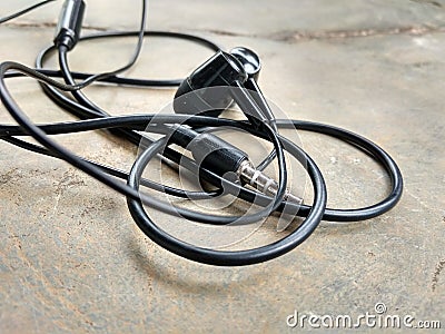 The earphone wire is black. Stock Photo