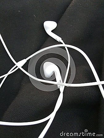 Earphones place on the black background Stock Photo